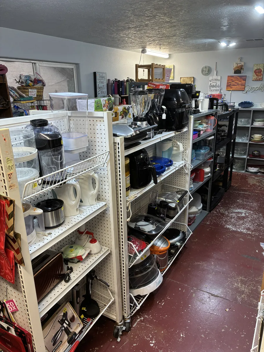 Shelves of blenders, coffee makers, slow cookers and kitchen containers at BAM Thrift store